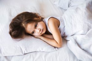 cute little girl sleeping in her bed at home