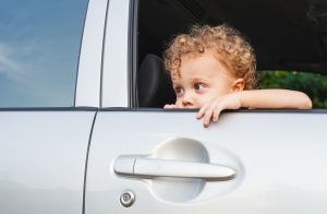 sad boy near car window