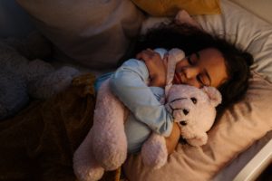 Malatonin and kids, child sleeping hugging bear
