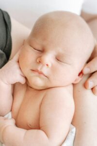 Sleeping baby with hand by head
