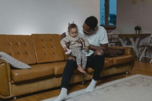 Dad on the couch with a baby