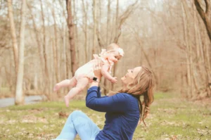 Mother holding baby up in the air