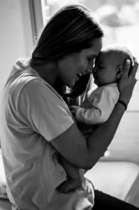 Woman holding a baby to her face