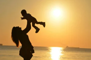 Woman holding a baby up in the air