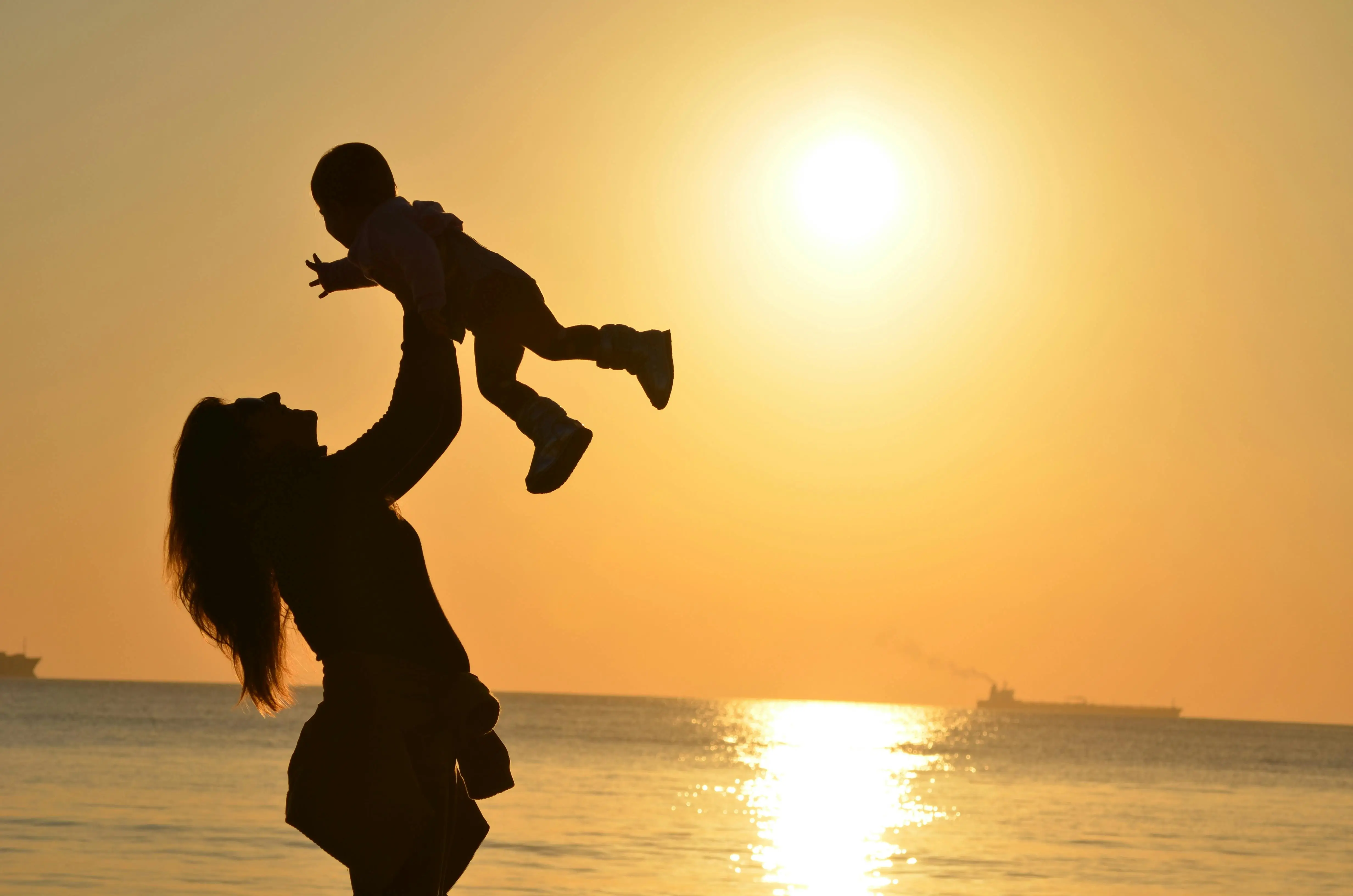 Woman holding a baby up in the air