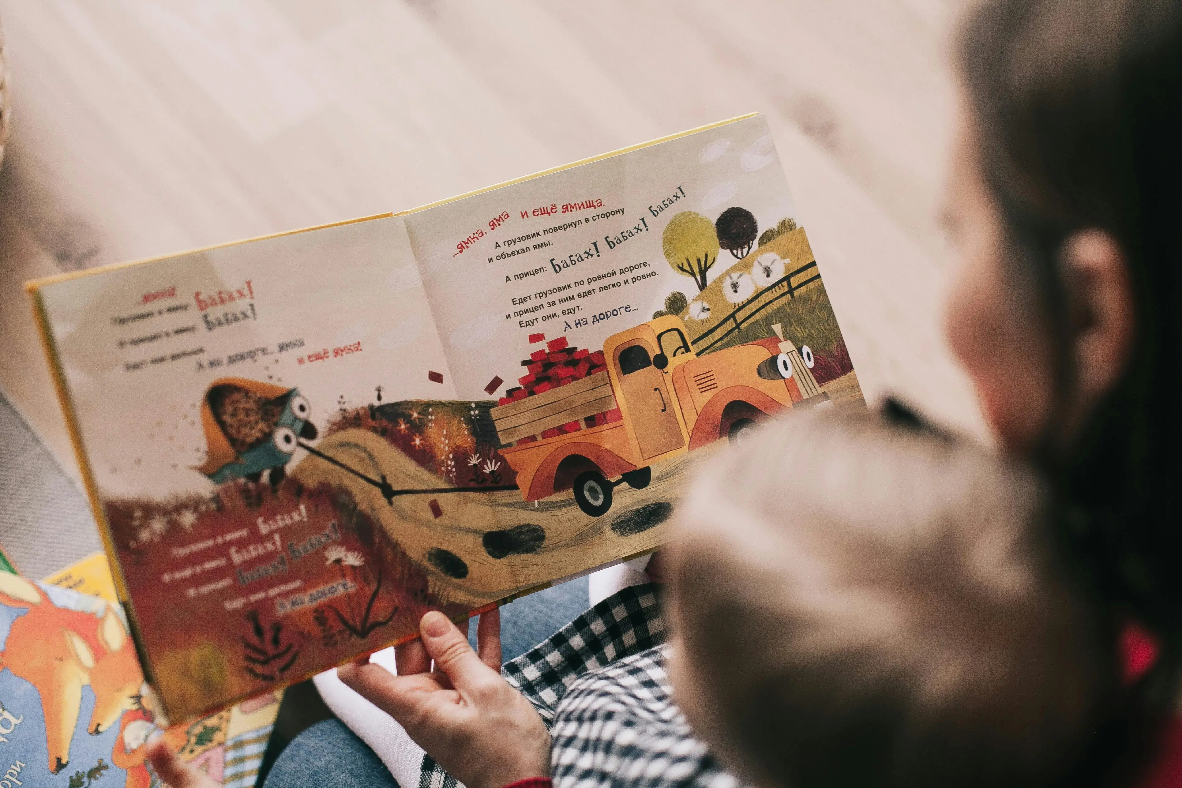 Mother and child reading a book together