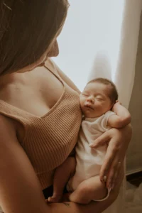 Mother holding sleeping baby in her arms