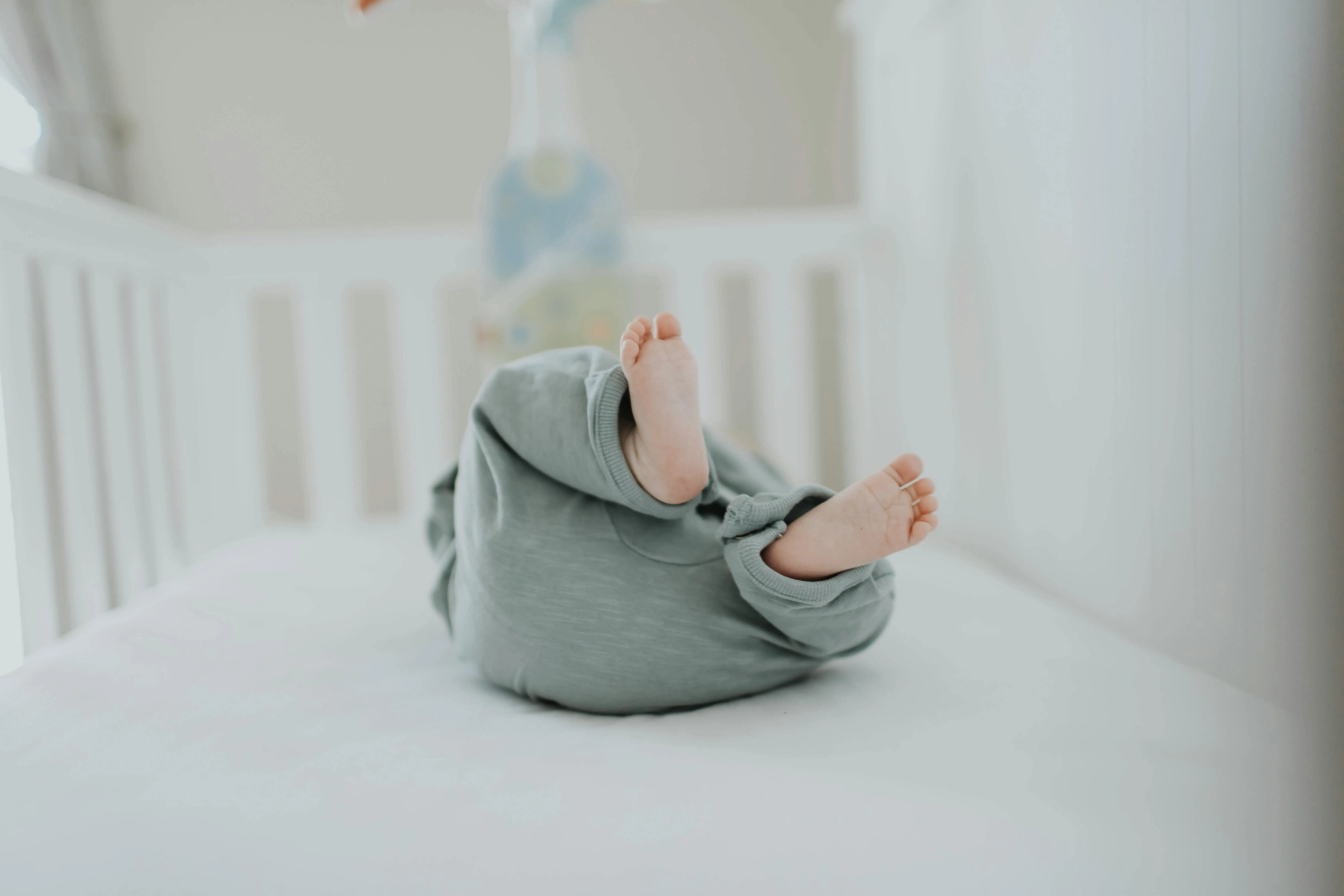 Feet view of baby on back in crib